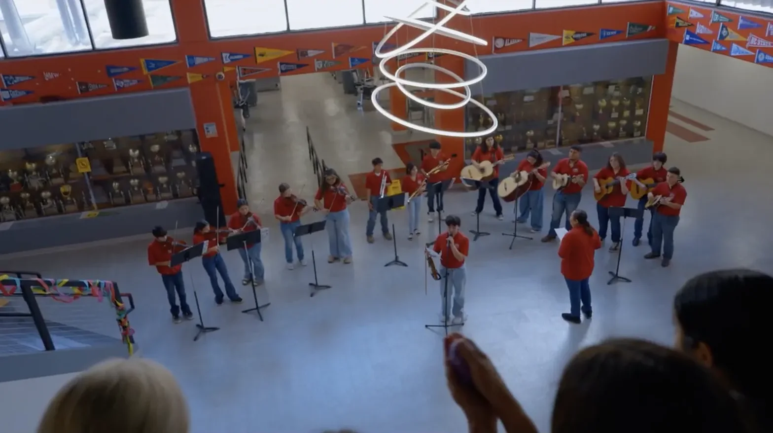 Student musicians performing together in a school atrium