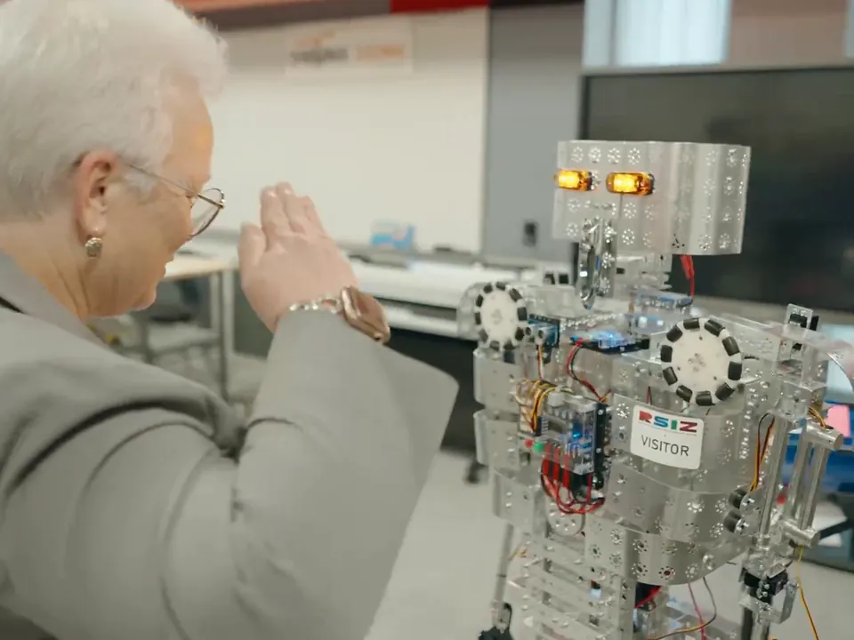 An educator tries out a student-built robot in a STEM lab, the kind of enrichment Fullmind supports.