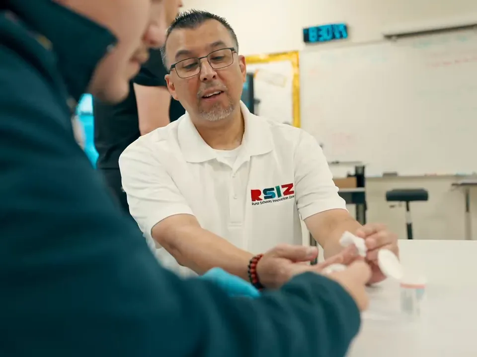 An educator works one-on-one with a student on an assignment, the kind of support live homework help provides.